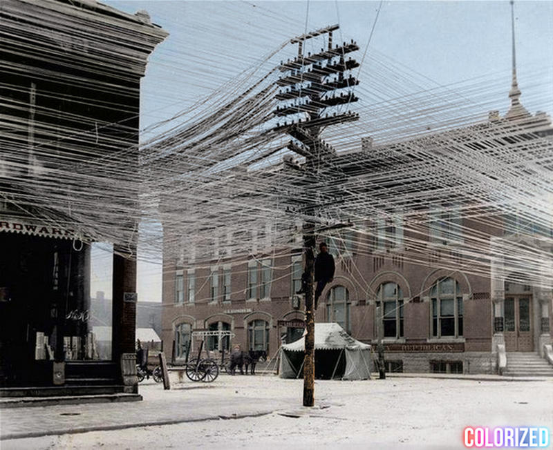 A lineman working on telephone lines at an intersection in Pratt, Kansas in 1911..jpg