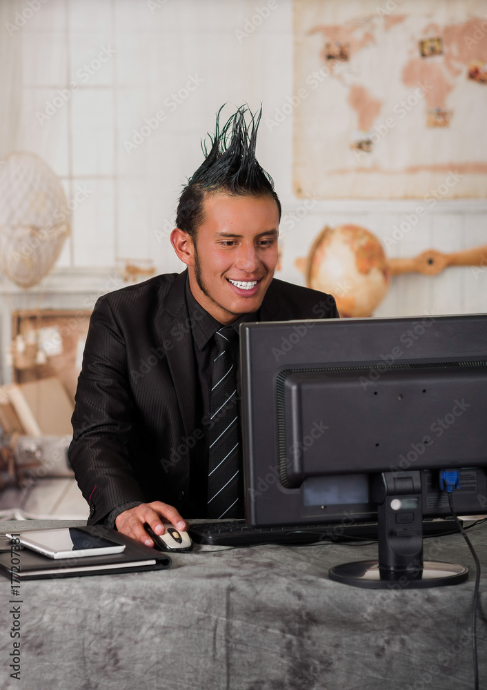 Close up of smiling office punk worker wearing a suit with a crest, working  in a computer, in a blurred background Stock Photo | Adobe Stock