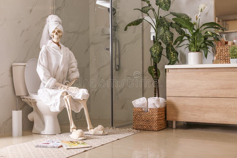 skeleton-bathrobe-sitting-toilet-bowl-170615823.jpg